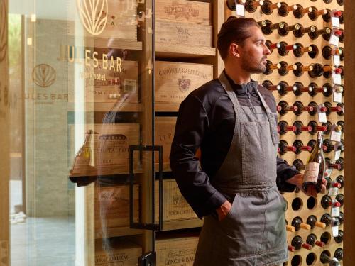 a man standing in front of a wine display at Parkhotel Kortrijk in Kortrijk