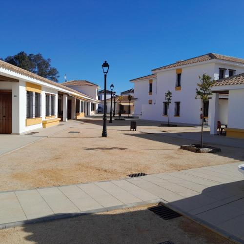 a empty street in a town with buildings at La Cancela Apartamentos Turísticos in El Rocío