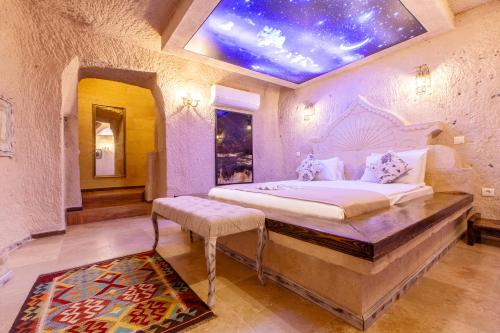 a bedroom with a bed with a star ceiling at Karlık Cave Suite Cappadocia in Uchisar