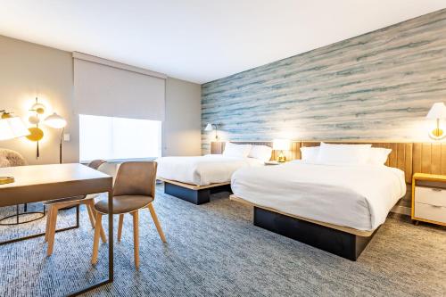 a hotel room with two beds and a desk at TownePlace Suites by Marriott Raleigh - University Area in Raleigh