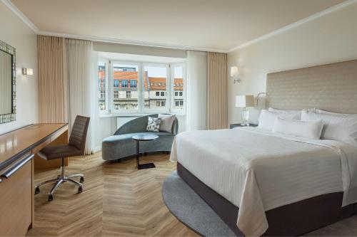 a hotel room with a bed and a desk at The Westin Grand Berlin in Berlin