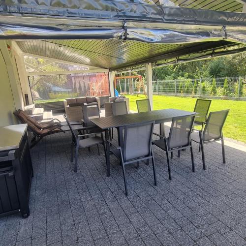 a table and chairs sitting under a tent at ZuMiLu House in Zagórz