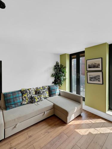 a living room with a couch and a window at Granada Apartments Berkeley in Blackpool