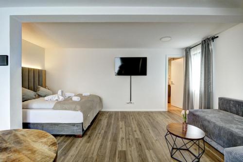 a hotel room with a bed and a couch at MK Apartments in Aulendorf