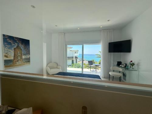 a living room with a view of the ocean at Tierratlanta Suites in Zahara de los Atunes