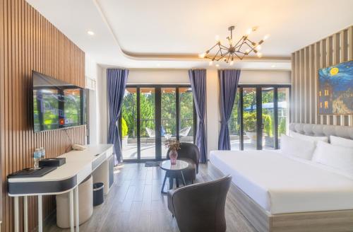 una camera da letto con un grande letto bianco e una scrivania di TP Dalat Hotel a Da Lat