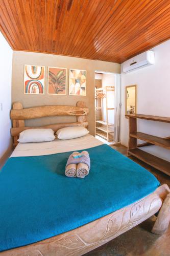 a bedroom with a large bed with two towels on it at Pousada Flor de Maio - Vila De São Jorge in Sao Jorge