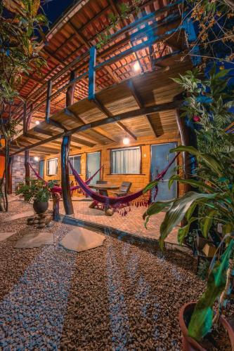 a room with a hammock in a house at Pousada Flor de Maio - Vila De São Jorge in Sao Jorge