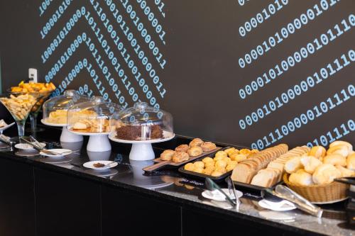 a buffet with various types of pastries on a table at Ibis Styles Barretos in Barretos