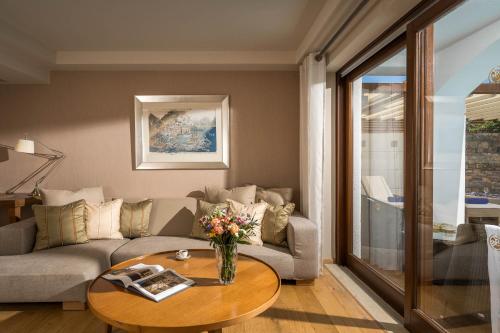 a living room with a couch and a table at Creta Maris Resort in Hersonissos