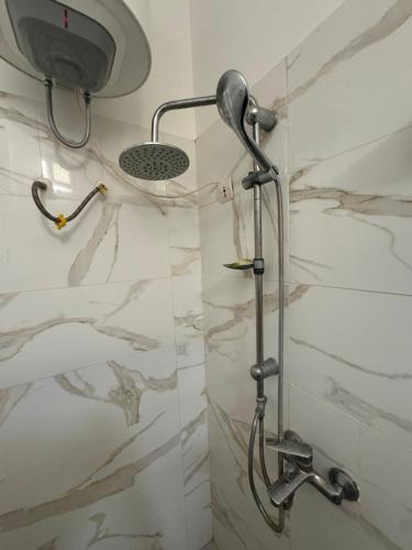 a shower in a bathroom with a marble wall at Somone houses in Somone