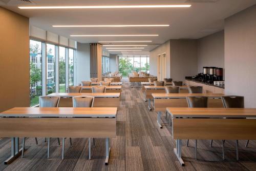 a row of desks and chairs in a room with windows at Residence Inn Miami Sunny Isles Beach in Miami Beach
