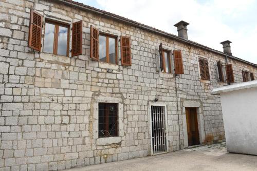 an old brick building with windows on it at Old House Bozovic in Nikšić
