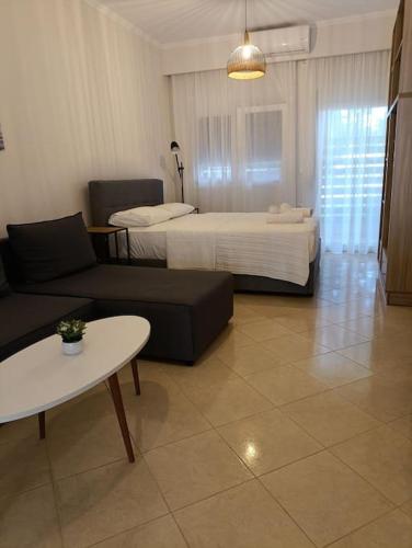 a room with two beds and a couch and a table at Lydia's house in Agiá