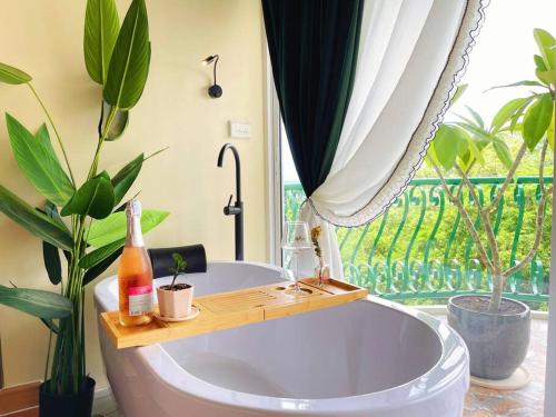 a bathroom with a tub with plants and a window at 912 Good view &2 minutes walk to one Nimman Maya in Chiang Mai