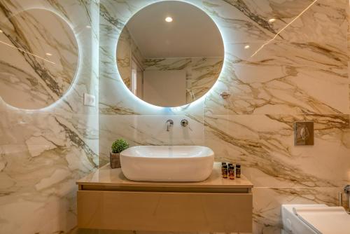 a bathroom with a sink and a mirror at Kiwi Boutique Studios in Kissamos