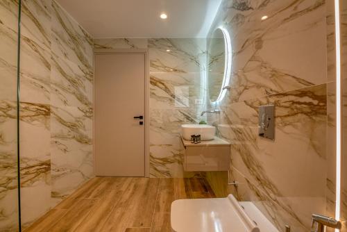 a bathroom with a white toilet and a sink at Kiwi Boutique Studios in Kissamos