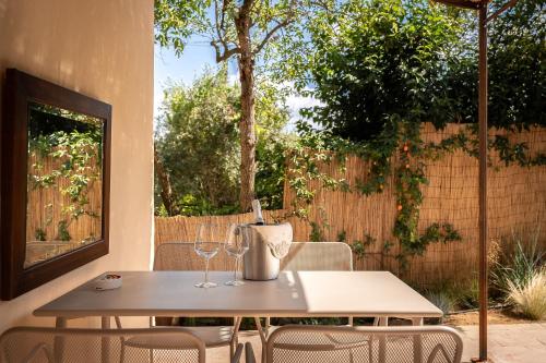 a table and chairs with wine glasses on a patio at Fontarcella, Heart & Roots in Petrignano sul Lago