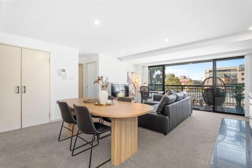 a living room with a table and a couch at City Life 2BR Apt with Pool,Gym, Sauna, Carbay in Perth
