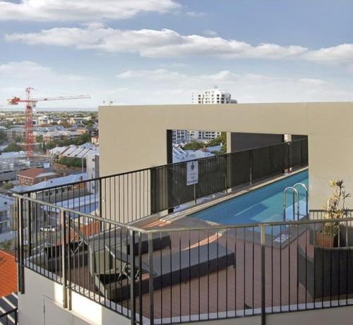 a balcony with a swimming pool on top of a building at City Life 2BR Apt with Pool,Gym, Sauna, Carbay in Perth