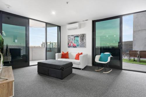a living room with a couch and a chair at Brilliant 2BR Apartment in Belconnen - Hosted by Canstay in Belconnen