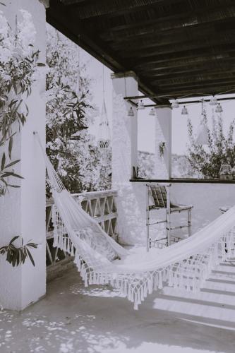 a hammock on the porch of a house at Hacienda el Tarajal in Priego de Córdoba