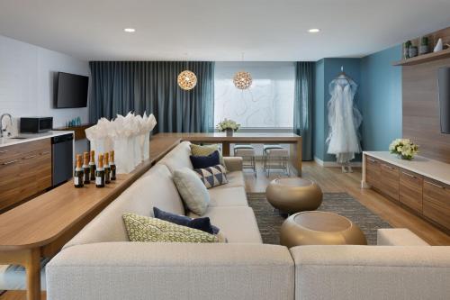 a living room with a white couch and a kitchen at Element Atlanta Buckhead in Atlanta