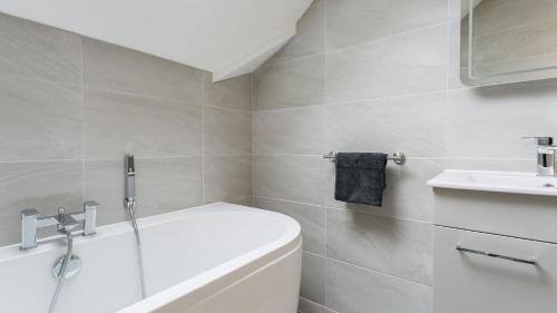 a bathroom with a white tub and a sink at The Nook in Valley