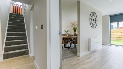a home with a staircase and a dining room at The Nook in Valley