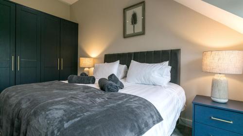a bedroom with a large bed with two stuffed animals on it at The Nook in Valley