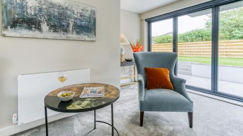 a living room with a table and a chair at The Nook in Valley