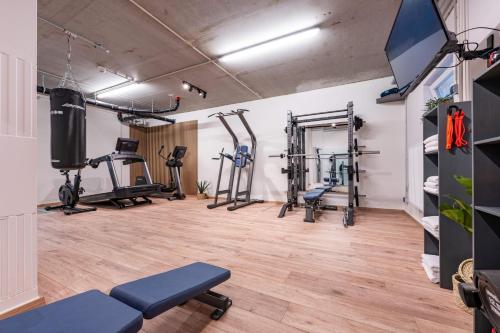 a gym with several treadmills and exercise machines at Ostsee Apartmenthotel in Graal-Müritz