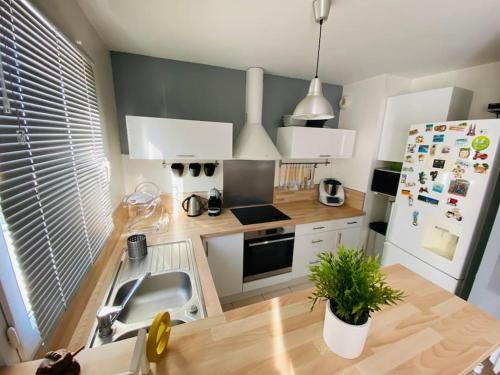 une cuisine avec un évier et un réfrigérateur dans l'établissement Appartement 2 chambres, à Mantes-la-Ville