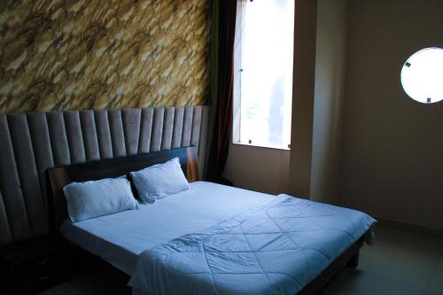Cama o camas de una habitación en Sangam Hotel