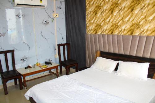 Cama o camas de una habitación en Sangam Hotel