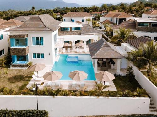an aerial view of a house with a pool and umbrellas at Royal 3 Bedroom Villa Lifestyle in San Felipe de Puerto Plata