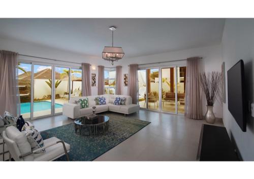 a living room with a couch and a table at Royal 3 Bedroom Villa Lifestyle in San Felipe de Puerto Plata