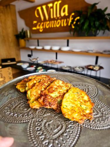 a plate of food on top of a table at Willa Zagroniówka in Istebna