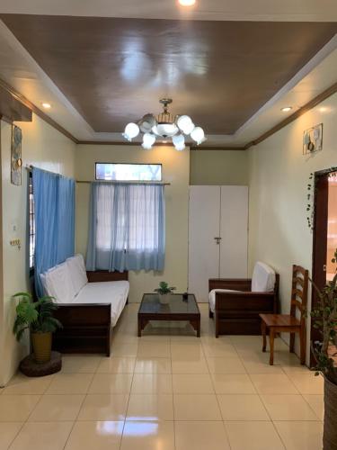 a living room with a couch and a table at Four Twenty Hostel in General Luna