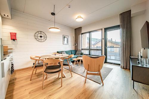 a living room with a table and chairs at Ski Chalet C11 Levi Center incl 2 ski passes by Aavalevi in Levi