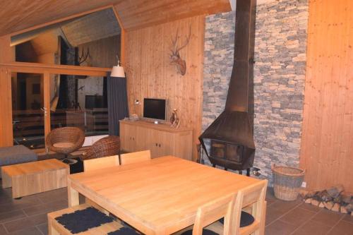 a living room with a wooden table and a fireplace at Apartment Cristal in Anzère