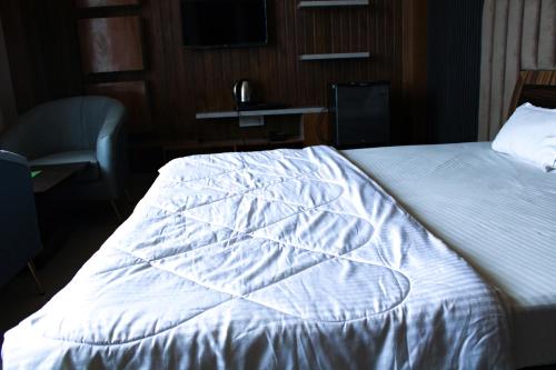 Cama o camas de una habitación en Sangam Hotel