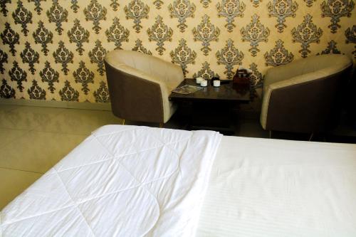 Cama o camas de una habitación en Sangam Hotel