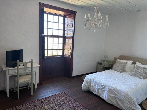 a bedroom with a bed and a desk and a window at Sombrero de Pico C in El Paso