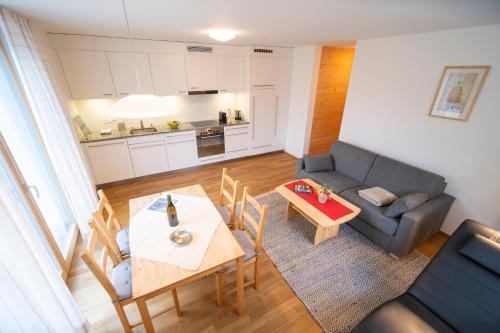 a living room with a couch and a table at Fionas 256 in Ftan