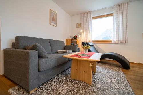 a living room with a couch and a coffee table at Fionas 256 in Ftan