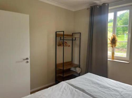a bedroom with a bed and a window at Feriendomizil im Saarschleifenland in Mettlach