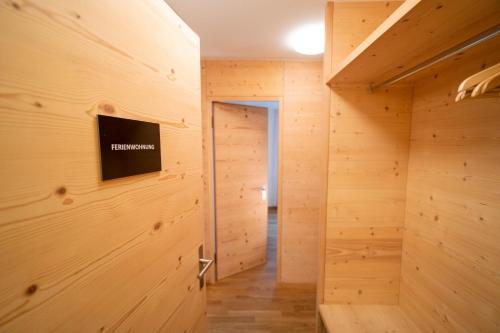 a room with wooden walls and a television on the wall at Fionas 256 in Ftan