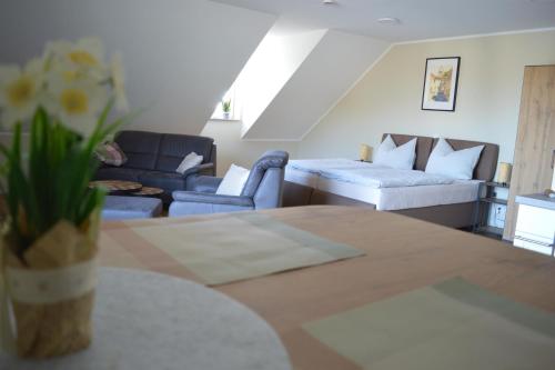 a living room with a couch and a bed at Feriendomizil im Saarschleifenland in Mettlach