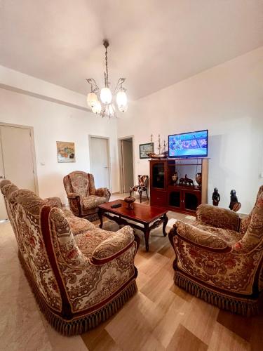 a living room with couches and a tv at Grandmas holiday home Sicily in Giarre
